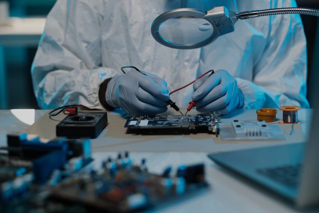 semiconductor technician working using a magnifying glass