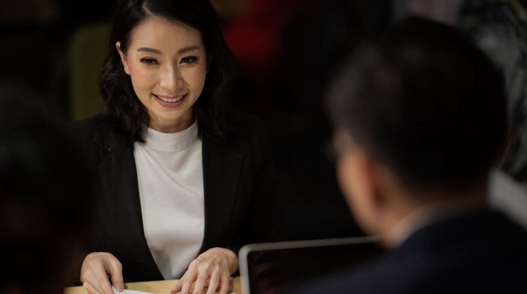 Employer speaking with candidate during interview.