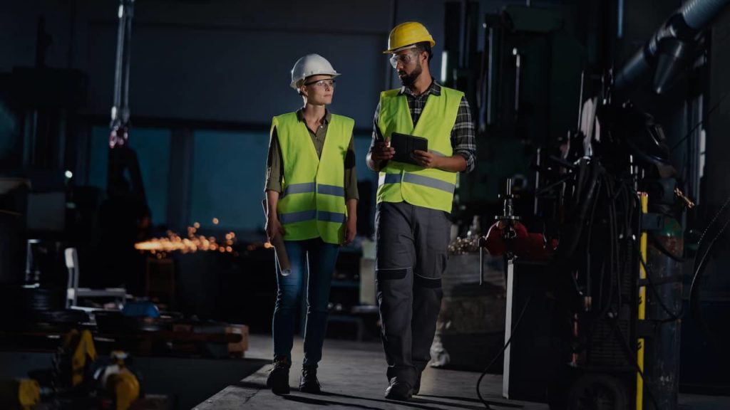 Two employees working at a manufacturing company.