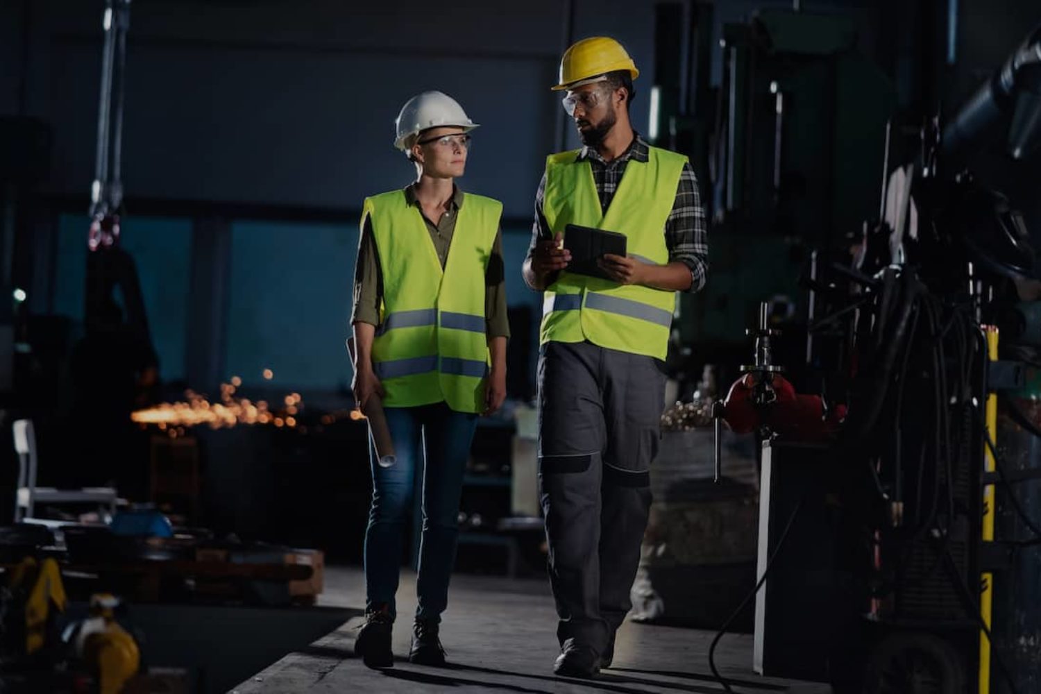 Two employees working at a manufacturing company.