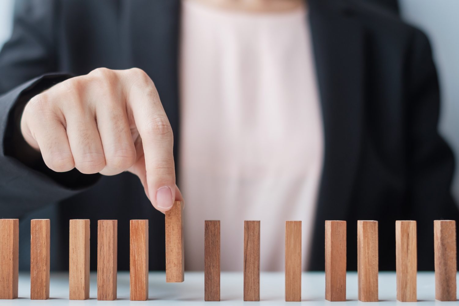 Businesswoman hand pulling leader man wooden from crowd of block. Toxic People, Human resource management, Recruitment, Teamwork and leadership Concepts (Businesswoman hand pulling leader man wooden from crowd of block. Toxic People, Human resource ma