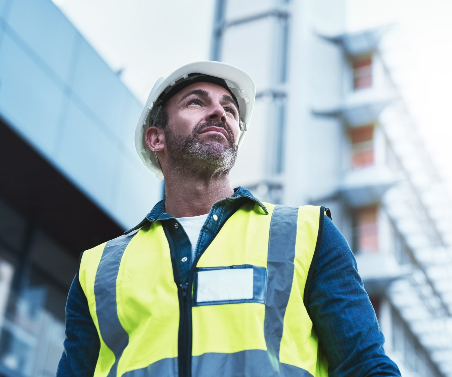 Hire the best architect in town. Shot of a engineer standing in front of a building